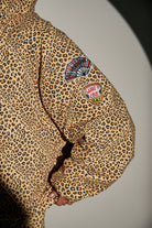 arm of sabbi big cat energy puffer jacket patches