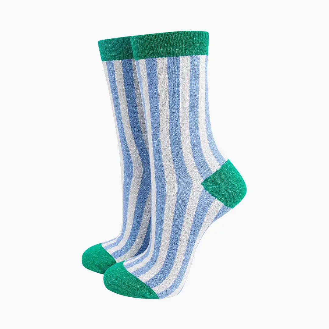 Pair of socks with blue and white stripes and green accents on a white background