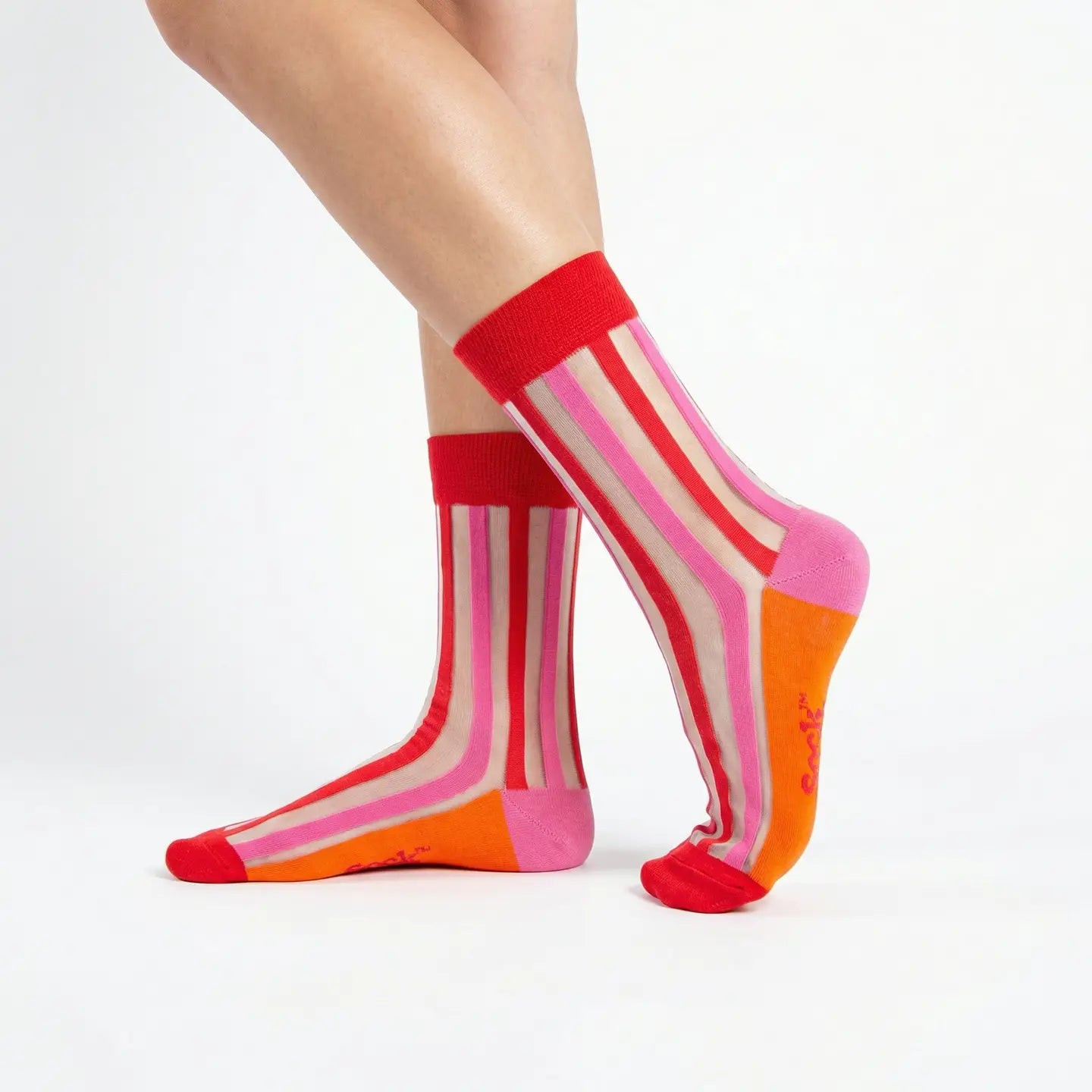 Colorful striped socks worn by a person on a white background